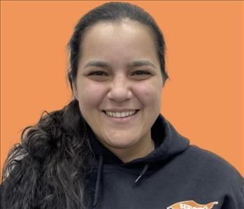 woman in front of orange wall