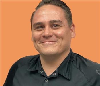 man in front of orange background