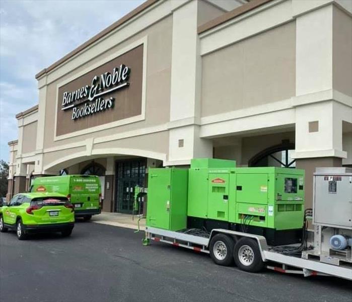 Green SERVPRO vehicles outside a Barnes and Noble. 