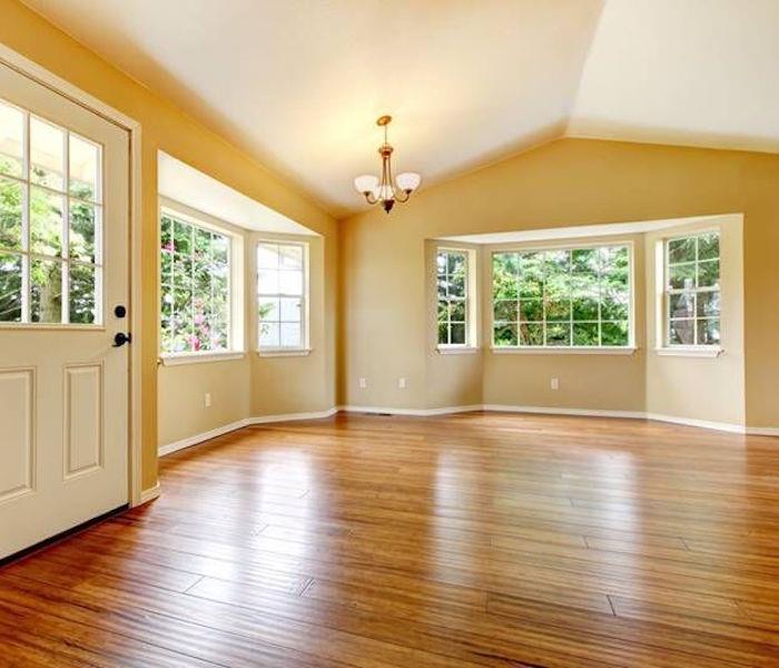 Yellow room with wood floors.