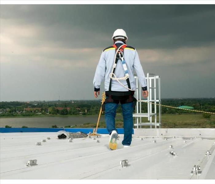 Construction engineer wearing safety uniform inspection metal roofing work for roof industrial 